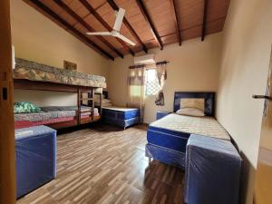 a bedroom with two bunk beds and wooden floors at Don Roque in Piribebuy
