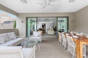a living room with a couch and a table and chairs at Element Bay 5 in Cap Malheureux