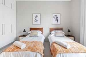 two beds sitting next to each other in a bedroom at Element Bay 5 in Cap Malheureux +43 photos