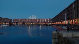 a large body of water in front of buildings at Anfield Stadium House - Free Parking in Liverpool