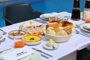 a table with a breakfast of bread and eggs at Outeyro Retreat Country House in Marco de Canaveses