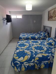 a bedroom with two beds and a television in it at Práctico y céntrico departamento in Salamanca