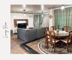 a living room with a couch and a table at 2 Bedrooms Spacious flat 7 mins to Airport in Cairo