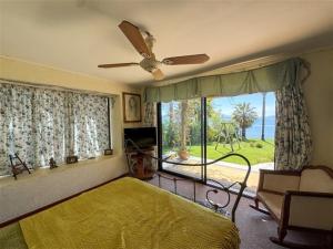 a bedroom with a bed and a couch and a window at El Estero Lago Rapel in El Estero +17 photos