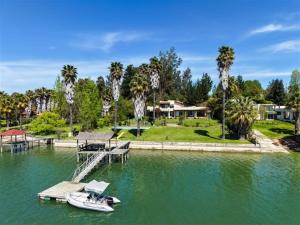 a boat is docked at a dock in the water at El Estero Lago Rapel in El Estero