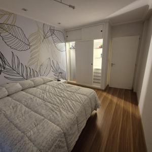 a bedroom with a bed and a wall mural at Depto nivel ejecutivo in Villa Regina