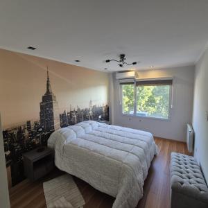 a bedroom with a large bed and a large window at Depto nivel ejecutivo in Villa Regina