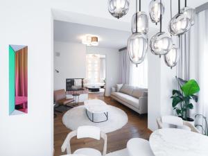 a living room with a couch and a table and chairs at Stadtchalet Forsthaus in Kitzbühel
