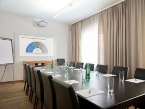 a meeting room with a long table and chairs at Stadtchalet Forsthaus in Kitzbühel +45 photos