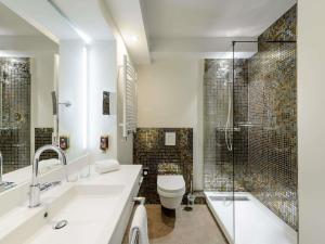 a bathroom with a sink and a toilet and a shower at Ibis Styles Regensburg in Regensburg +187 photos