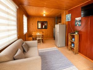 a living room with a couch and a refrigerator at Turismo La Isla in Salto del Laja