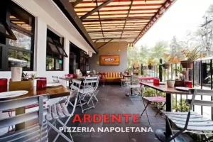a restaurant with tables and chairs on a patio at Habitacion en residencia compartida in Mexico City +3 photos
