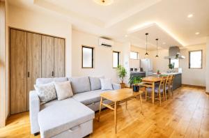 a living room with a couch and a table at Wight Turtle Villa -Ishigaki Blue Retreat in Ishigaki Island