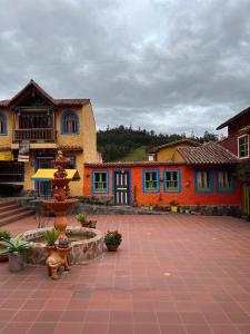 a building with a fountain in the middle of a courtyard at La Puerta - Pueblito Boyacense in Duitama