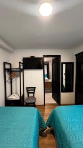 a bedroom with two bunk beds and a mirror at CASA LAURA hotel & suites in Cuenca