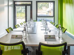 a large conference room with a long table and chairs at ibis Styles Montelimar Centre in Montélimar