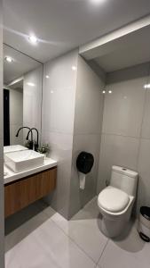 a bathroom with a toilet and a sink at CASA LAURA hotel & suites in Cuenca