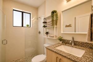 a bathroom with a sink and a toilet and a shower at Avi Lux Stay in Miami