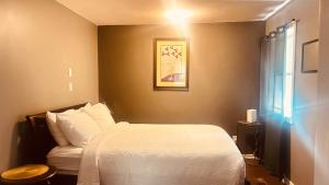 a bedroom with a white bed and a window at Wavy Daze in Wasaga Beach in Wasaga Beach