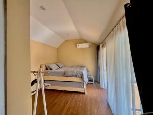 a small bedroom with a bed and a window at Cabin Inn by Batu Pineus in Pengalongan