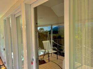 a sliding glass door leading to a porch with a deck at Cabin Inn by Batu Pineus in Pengalongan +38 photos