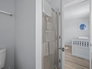 a bathroom with a toilet and a shower door at Oceanfront vacation home - EAST in Emerald Isle +22 photos