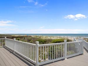 a deck with a view of the beach at Oceanfront vacation home - EAST in Emerald Isle