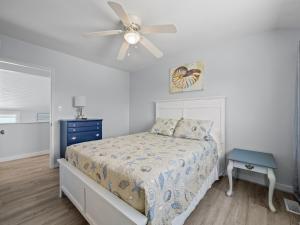 a bedroom with a bed and a ceiling fan at Oceanfront vacation home - EAST in Emerald Isle