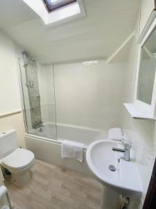 a bathroom with a sink and a toilet and a shower at Mill View-an idyllic base to explore The Cotswolds in Northleach