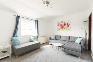 a living room with two couches and a table at Mill View-an idyllic base to explore The Cotswolds in Northleach +28 photos