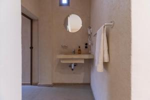 a bathroom with a sink and a mirror at Taghazout Waves Surf camp & Hotel in Aourir