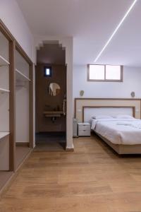 a bedroom with a large bed and a mirror at Taghazout Waves Surf camp & Hotel in Aourir