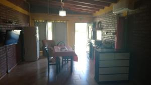 a kitchen with a table and chairs and a refrigerator at Departamento Fede 1 in Carpintería