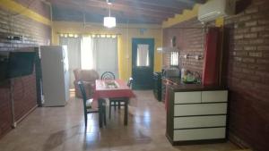 a small kitchen with a table and a refrigerator at Departamento Fede 1 in Carpintería