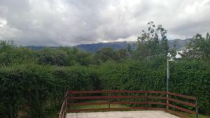 a wooden bench sitting on top of a field at Departamento Fede 1 in Carpintería +3 photos