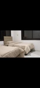 a group of three beds in a room at شاليهات ذهب in Amman +17 photos