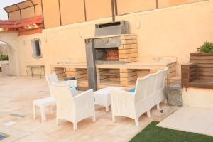 a patio with a table and chairs and a grill at شاليهات ذهب in Amman