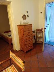 a room with a wooden dresser and a bedroom at Bacchus-hof in Báta