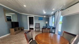 a dining room with a table and a living room at Andros Waterside Retreat in Deep Creek