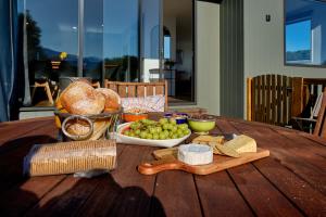 a wooden table with a bunch of food on it at Sunny Balcony | Mountain Views | Relaxed - KK04313 in Kaikoura