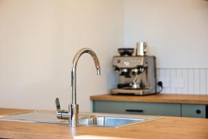 a kitchen counter with a sink and a mixer at Sunny Balcony | Mountain Views | Relaxed - KK04313 in Kaikoura