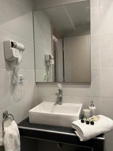 a bathroom with a white sink and a mirror at Il Mondo City Center in Stavros +26 photos