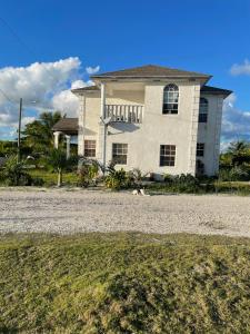 a house on a gravel road in front at Andros Waterside Retreat in Deep Creek