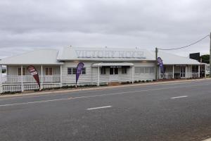 a white building with a sign that reads victory motel at Victory Hotel Motel Gympie in Gympie
