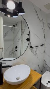 a bathroom with a white sink and a mirror at Studio Mirador in San Carlos de Bariloche