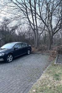 a black car parked on a brick road at modernes gemütliches Apartment in Gießen