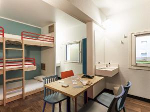 a small room with a table and a bunk bed at hotelF1 Chartres in Le Coudray