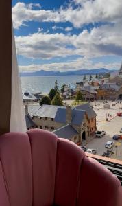 a room with a couch and a view of a town at Studio Mirador in San Carlos de Bariloche