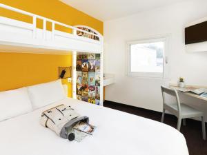 a bedroom with a bed and a desk and a bunk bed at hotelF1 Metz Actipole in Metz