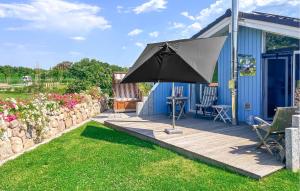 a blue house with an umbrella on a deck at Friedrichskoog-Deichblick 4 in Friedrichskoog +17 photos